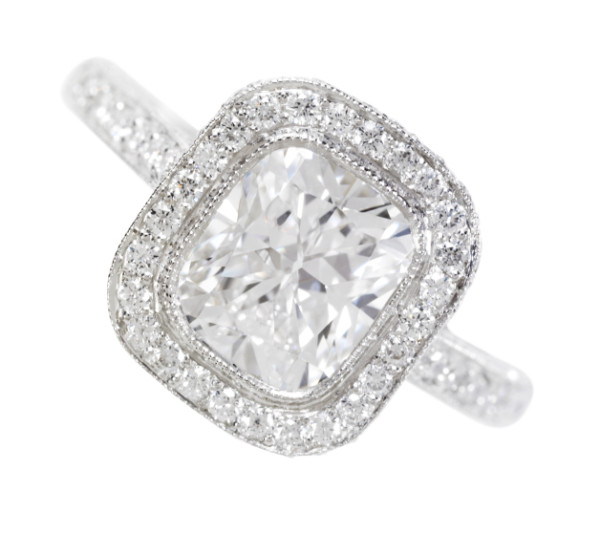 Rounded square diamond ring with diamond encrusted band, close-up.