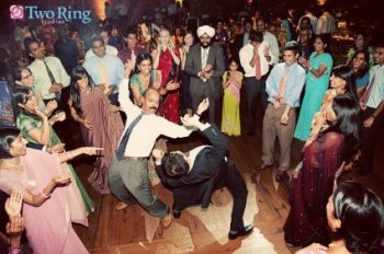 Two Indian men dancing at a wedding