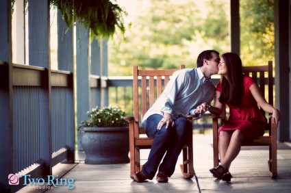 Man kisses his bride-to-be during an engagement session