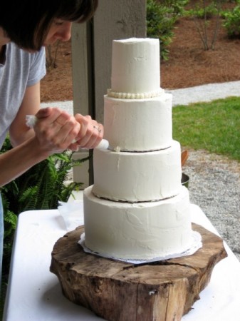 Piping buttercream onto my DIY Wedding Cake