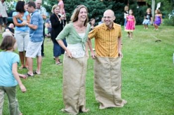 wedding guests participate in a sack race