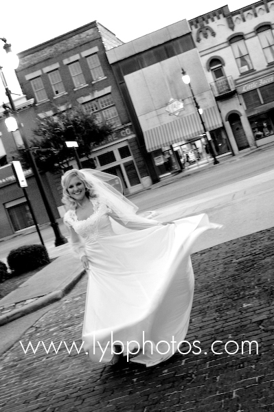 bride in mothers dress walks down a cobbled street