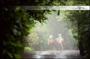 Bride and groom riding horses