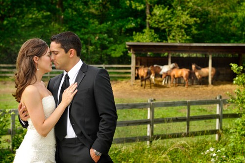 Bride and groom near horse farm