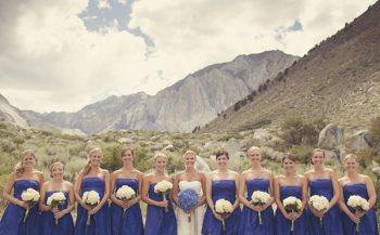 bride and bridesmaids line up in front of mountains