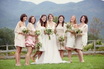 brides with bridesmaids in front of New Hampshire mountains