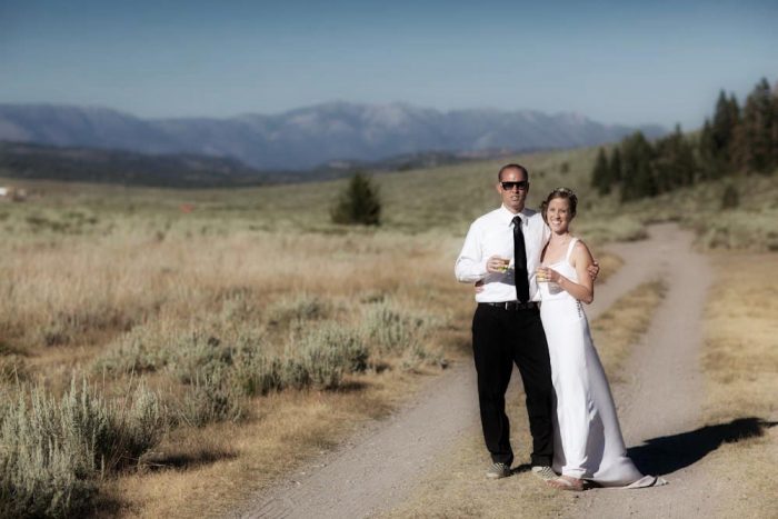 mammoth lakes bride and groom pose on an old mountain road