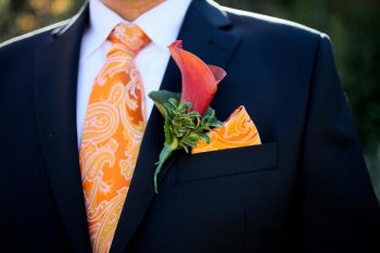 Groom's orange tie and boutonniere