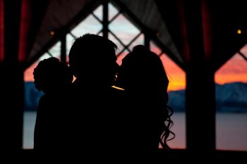 Bride and groom kiss in the sunset