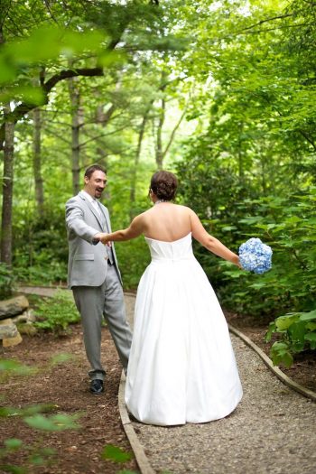 bride and groom in green woods