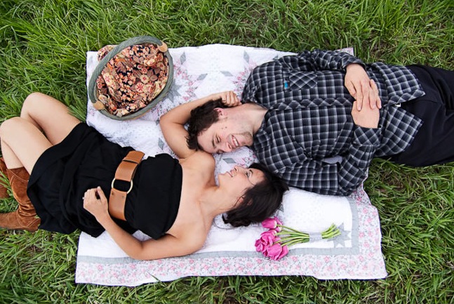 Colorado engaged couple lay on a picnic blanket