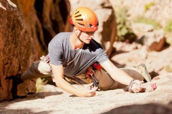 engaged man rock climbing