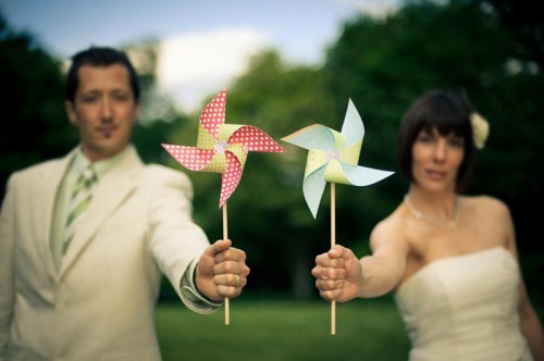 Hindsight bride and groom holding DIY paper pinwheels