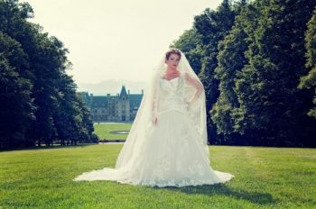 Bride stands on grand lawn at the Biltmore