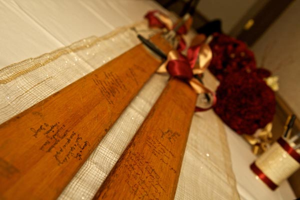 guests sign skis at a winter mountain wedding