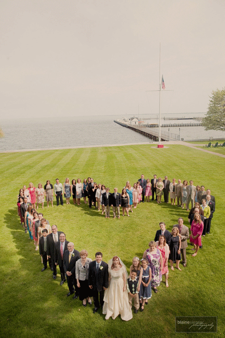 Wedding guests stand in a heart shape