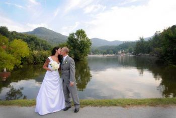 bride and groom kiss in the mountains