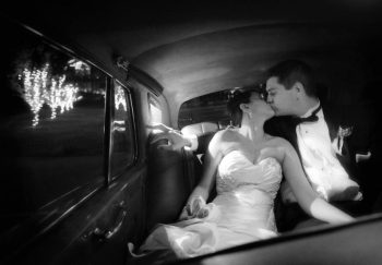 bride and groom kiss in the get away car