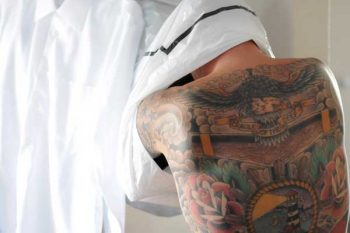 tattooed groom gets ready