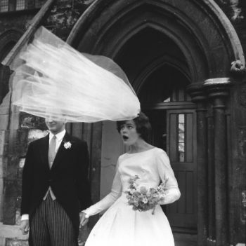 brides veil threatens to blow away in the wind
