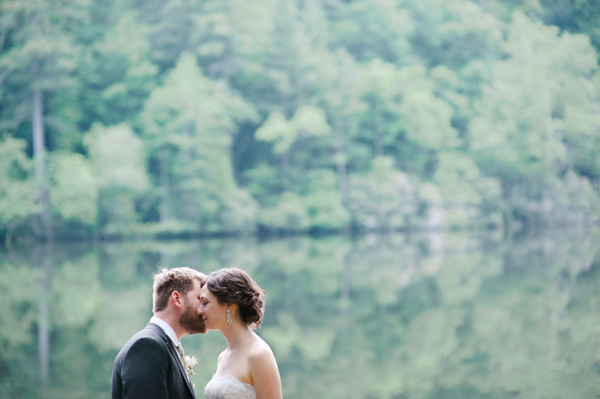 bride and groom by a lake