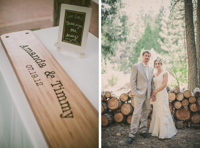vintage eco-chic wedding sign and bride and groom in front of wood pile
