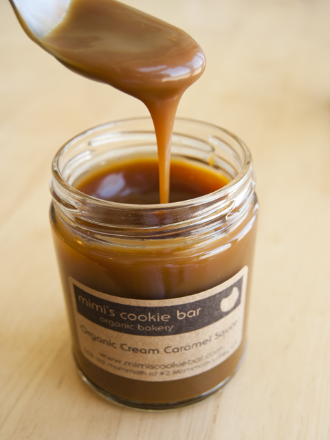 Pouring homemade organic caramel sauce from Mimis Cookie Bar in Mammoth Lakes