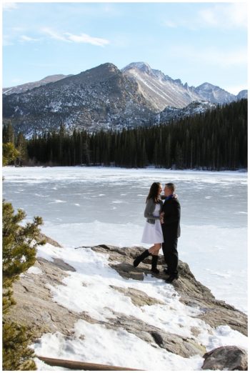 bride and groom stand near frozen big bear lake