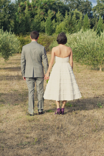 rustic bride and groom pose with their backs to the camera
