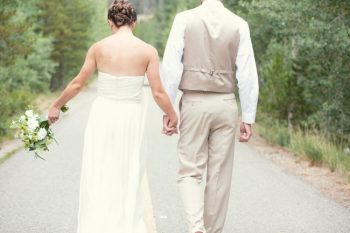 colorado bride and groom hold hands