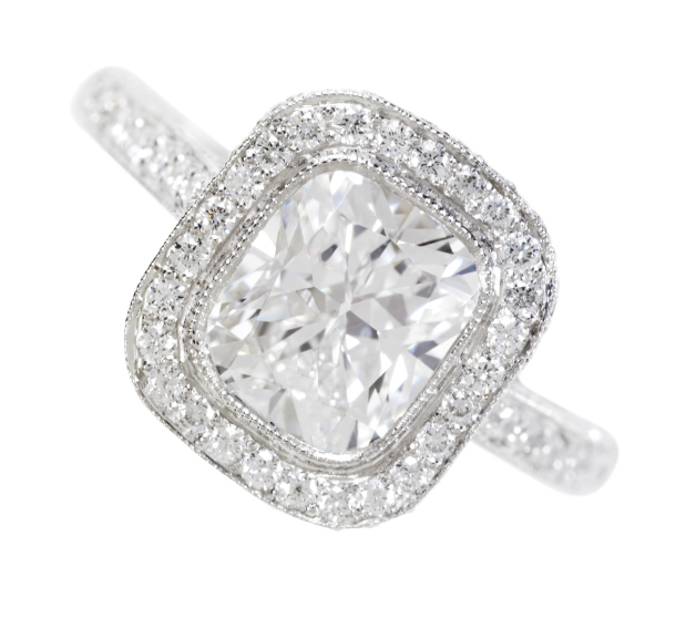 Rounded square diamond ring with diamond encrusted band, close-up.
