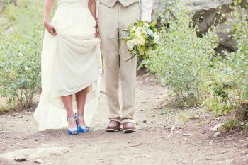 blue wedding shoes and green and white bouquet
