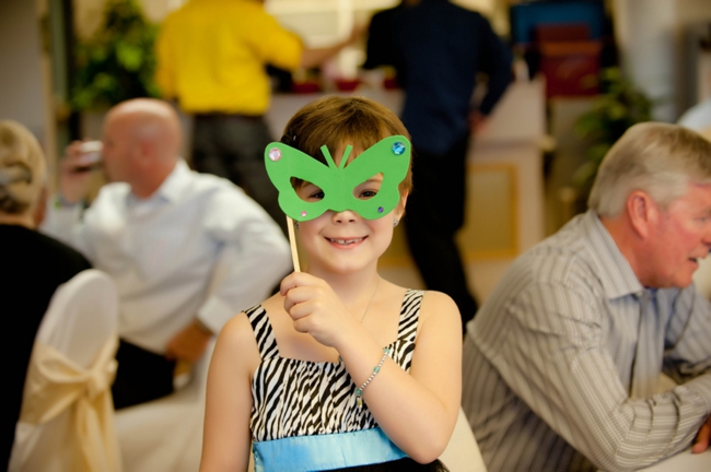 kids table at a wedding with paper butterfly mask