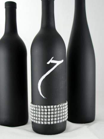Finished DIY chalkboard bottle centerpiece with bling