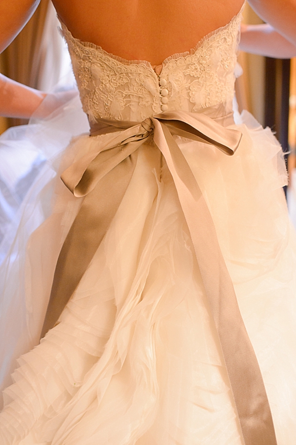 lace wedding gown with beige sash
