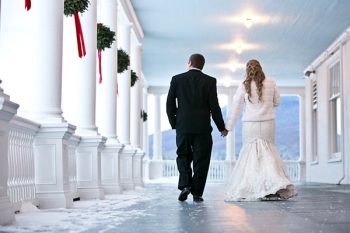 bride and groom hold hands as they walk away