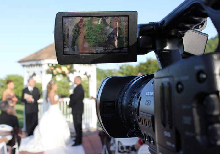 wedding videographer capturing a wedding ceremony