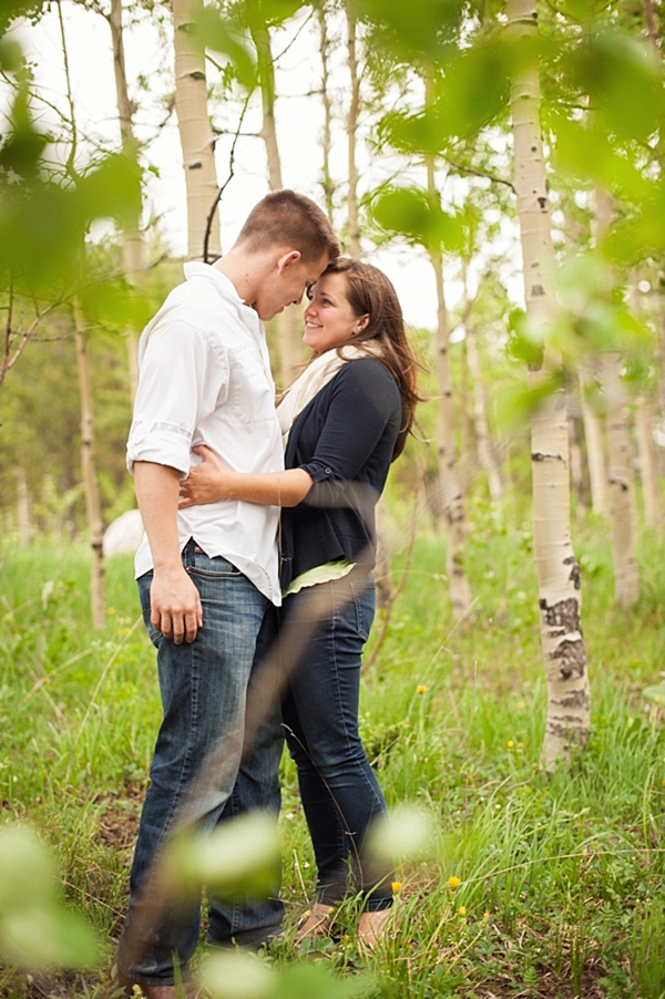 aspen engagement couple embrace in the woods