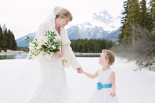 bride in the mountains with flower girl
