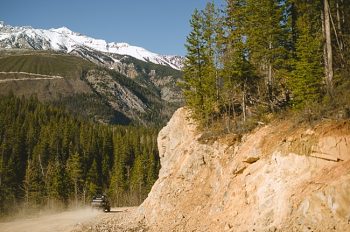 driving away British columbia mountain engagement shoot by Nordica Photography
