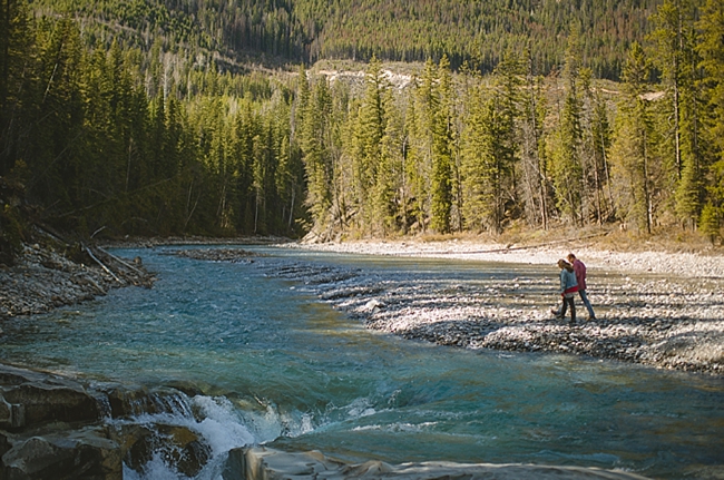 British columbia couple by a river at a mountain engagement shoot by Nordica Photography