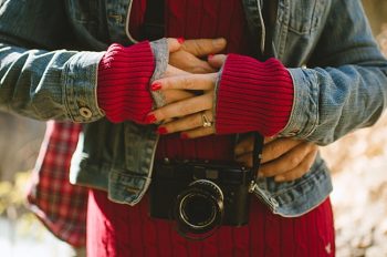 woman in red sweater holding a camera British Columbia by Nordica Photography