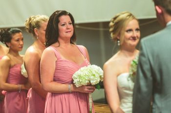 bridesmaids in pink at a church ceremony