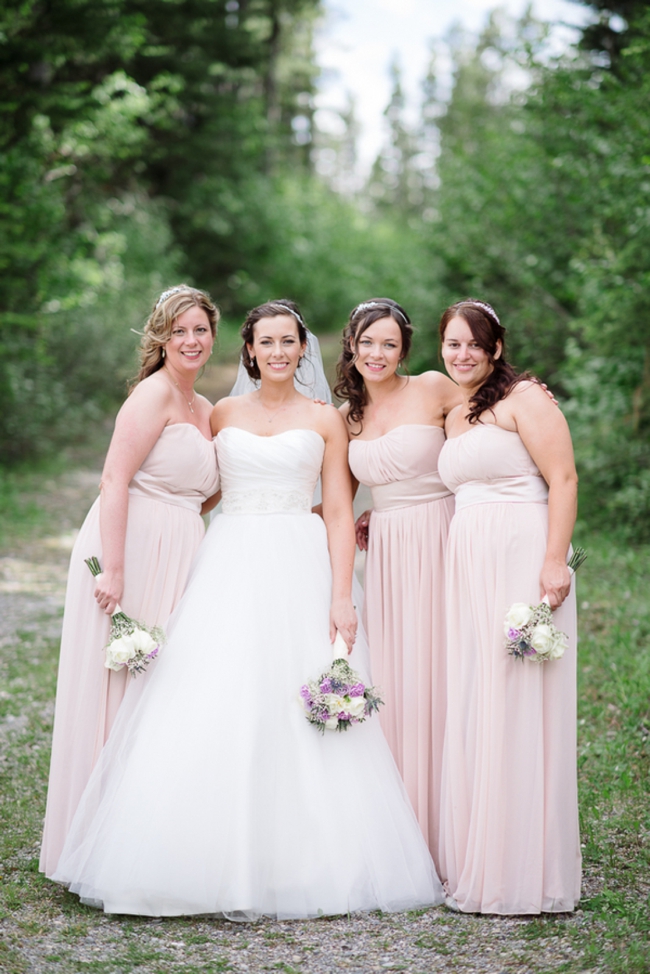 bridesmaids in pale pink gowns
