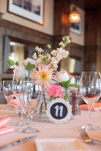 pink and peach center piece with chalkboard table number https://mountainsidebride.com