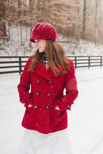 bride in red coat and red knit winter hat