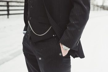 groom in a suit on a snowy day