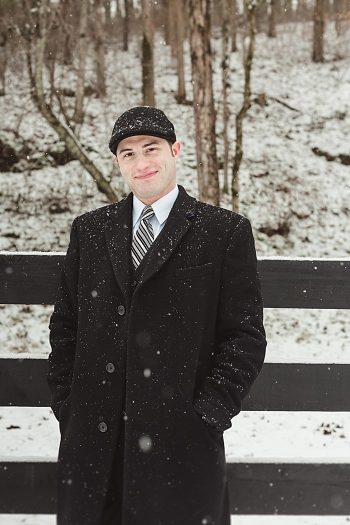 groom in a suit on a snowy day