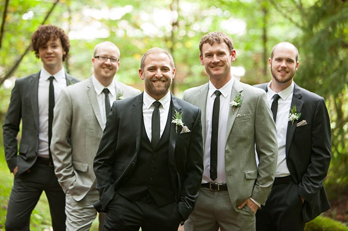 groomsmen in suits in woods