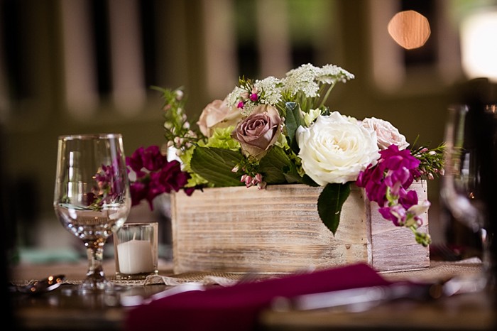 rustic wooden centerpiece with white and maroon flowers western North Carolina handmade wedding by Shutter Love Photography